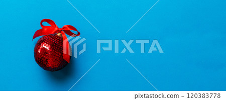 Christmas ball on colored background. decoration bauble with ribbon bow with copy space Christmas ball on colored background. decoration bauble with ribbon bow with copy space 120383778