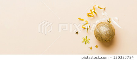 Christmas ball on colored background. decoration bauble with ribbon bow with copy space Christmas ball on colored background. decoration bauble with ribbon bow with copy space 120383784