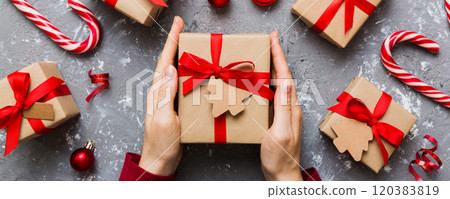 Woman hands holding gift box, preparing surprise for holiday, top view, Christmas and New Year concept Woman hands holding gift box, preparing surprise for holiday, top view, Christmas and New Year concept 120383819