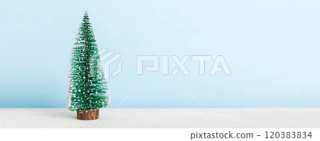 One small Christmas tree on colored background. new year decoration with copy space 120383834