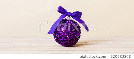 Christmas ball on colored background. decoration bauble with ribbon bow with copy space 120383868