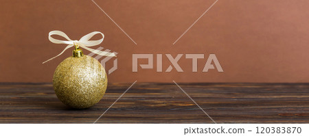 Christmas ball on colored background. decoration bauble with ribbon bow with copy space 120383870