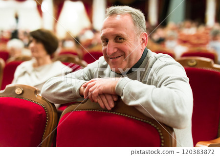 Mature man in theater watching a performance Mature man in theater watching a performance 120383872