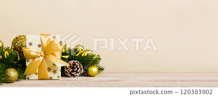 New Year Christmas mood, gift box, branches of a christmas tree, New Year decorations on a colored background 120383902