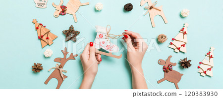 Top view of skates in female hands on blue background. Christmas decorations. New Year holiday concept Top view of skates in female hands on blue background. Christmas decorations. New Year holiday concept 120383930