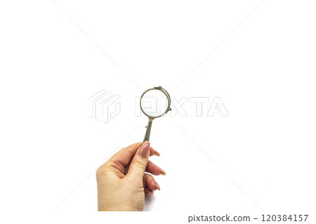 Hand hold an old vintage lorgnette from the middle of the nineteenth century on the white background Hand hold an old vintage lorgnette from the middle of the nineteenth century on the white background 120384157