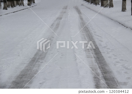 Vehicle ruts in the snow. Frozen road with print from wheels. 120384412