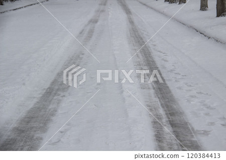 Vehicle ruts in the snow. Frozen road with print from wheels. 120384413