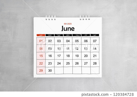 June 2025 desk calendar on gray cement wall background. 120384728