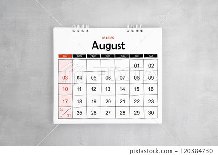 August 2025 desk calendar on gray cement wall background. 120384730