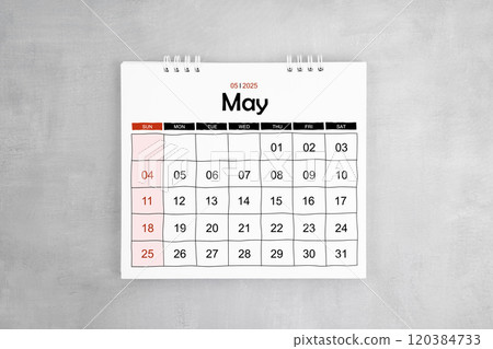 May 2025 desk calendar on gray cement wall background. 120384733