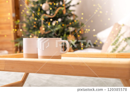 Two cups on wooden bed tray on Christmas holiday morning Two cups on wooden bed tray on Christmas holiday morning 120385578