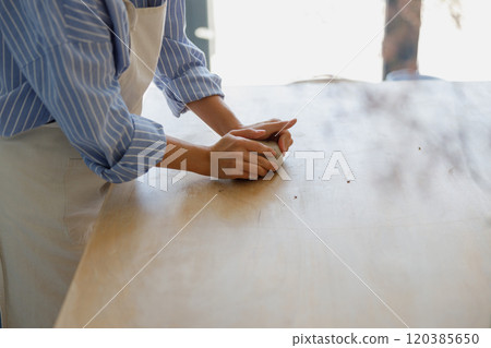 Artisan Craftsman Skillfully Kneading Fresh Dough on a Rustic Wooden Surface with Care 120385650
