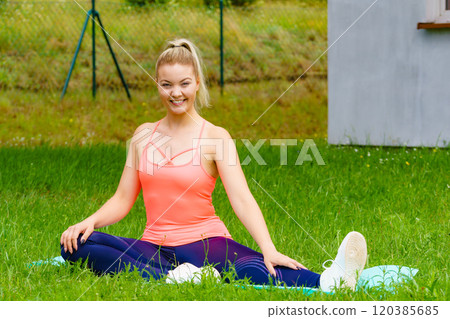 Woman doing exercises gym outdoors in garden Woman doing exercises gym outdoors in garden 120385685