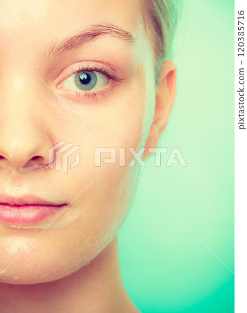 Woman in facial peel off mask. 120385716