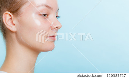woman in facial peel off mask. 120385717
