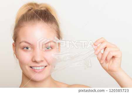 girl removing facial peel off mask girl removing facial peel off mask 120385723