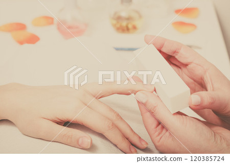 Preparing nails before manicure, beautician file nails Preparing nails before manicure, beautician file nails 120385724