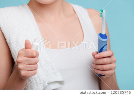 Young girl with toothpaste and toothbrush. 120385746