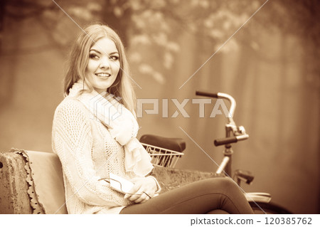 Girl listening to music mp3 relaxing in autumn park Girl listening to music mp3 relaxing in autumn park 120385762