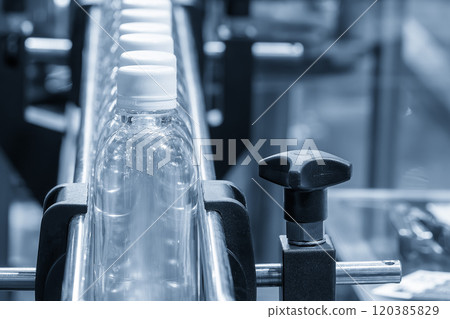 The  filled drinking water bottles  on the conveyor belt for filling process. 120385829