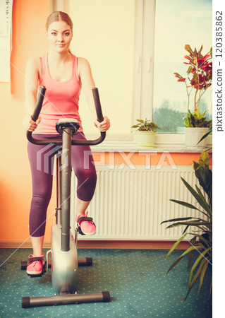Woman working out on exercise bike. Fitness. 120385862