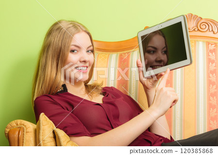 Fashion woman laying on sofa with pc tablet. 120385868