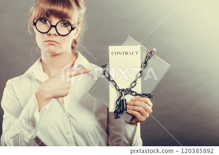 woman holding in hands contract and chain with padlock 120385892