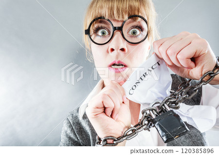 Furious woman with chained hands and contract 120385896