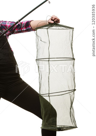 Woman hand holding empty fishing keepnet and rod 120385936