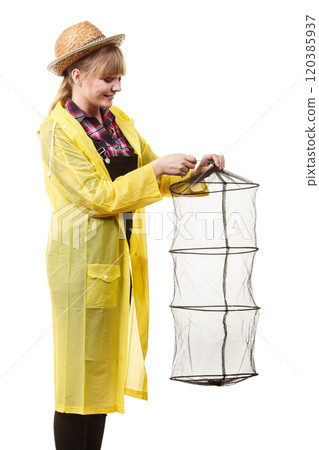 Happy woman holding empty fishing keepnet 120385937