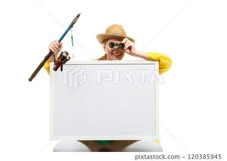 Happy woman with fishing rod holding board Happy woman with fishing rod holding board 120385945