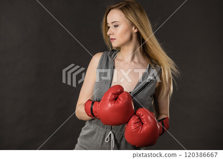 Beautiful woman with red boxing gloves Beautiful woman with red boxing gloves 120386667