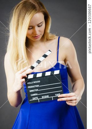 Woman holding professional film slate 120386687