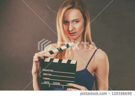 Woman holding professional film slate Woman holding professional film slate 120386690