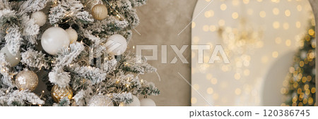 Banner close-up of a Christmas tree against a background of blurry garland lights. Banner close-up of a Christmas tree against a background of blurry garland lights. 120386745