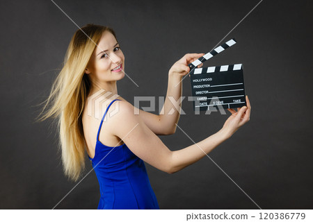 Woman holding professional film slate 120386779