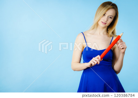 Woman confused thinking, big pencil in hand Woman confused thinking, big pencil in hand 120386784