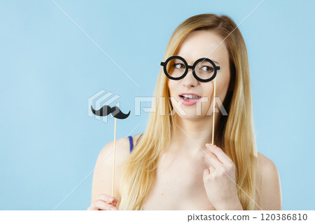 Woman holding carnival accessoies on stick 120386810