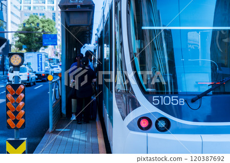 People boarding a streetcar 120387692