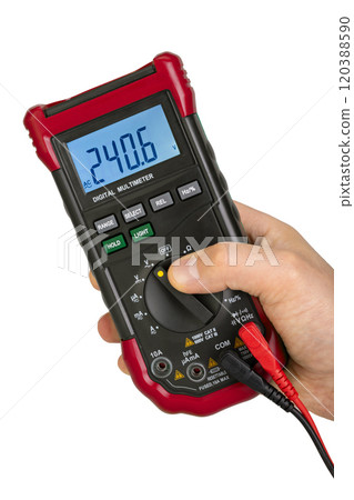 Hand Operating Digital Multimeter Displaying Voltage 120388590