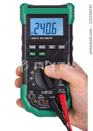 Hand Holding Green Digital Multimeter Displaying Voltage 120388591
