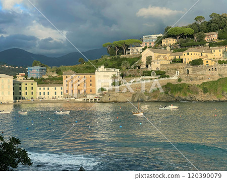 View from rock on Bay of Silence, fishing cove of town of Sestri-Levante, Italy. Tourism and recreation. Ecologically clean nature. Traditional old buildings. Historical center. 120390079