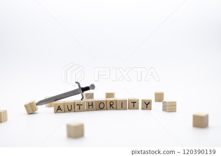 The wooden cubes with the word AUTHORITY and the weapon around against white background. The wooden cubes with the word AUTHORITY and the weapon around against white background. 120390139