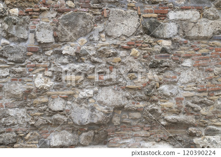 A Stone wall as background or texture. The background texture of the stone wall. A Stone wall as background or texture. The background texture of the stone wall. 120390224