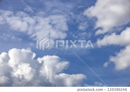 Blue sky background. The clouds on the sky. Colorful blue sky view in bright tones. Blue sky background. The clouds on the sky. Colorful blue sky view in bright tones. 120390248