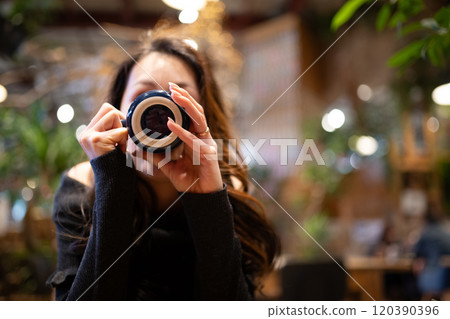 A woman with a coffee cup 120390396