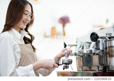 Barista tamping espresso grounds, showcasing precision and professionalism in a cafe setting. Barista tamping espresso grounds, showcasing precision and professionalism in a cafe setting. 120390610