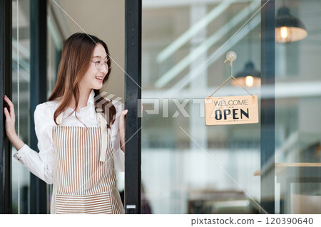 Cafe staff or owner opening the shop door, inviting customers with a friendly to start the day. Cafe staff or owner opening the shop door, inviting customers with a friendly to start the day. 120390640