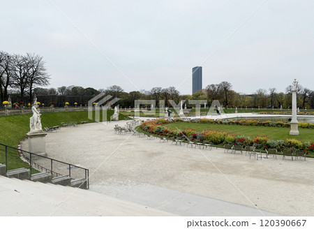 A fountain in the center of the Luxembourg Gardens in the 6th arrondissement of Paris. The building you can see in the distance is the Montparnasse Tower. 120390667